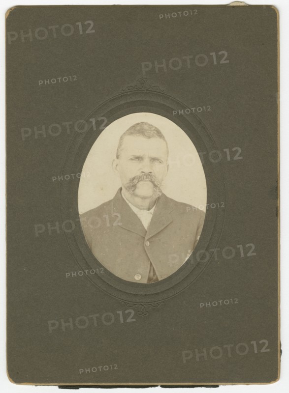 Photograph of a man with a mustache wearing a dark jacket, late 19th century. Creator: Unknown.
