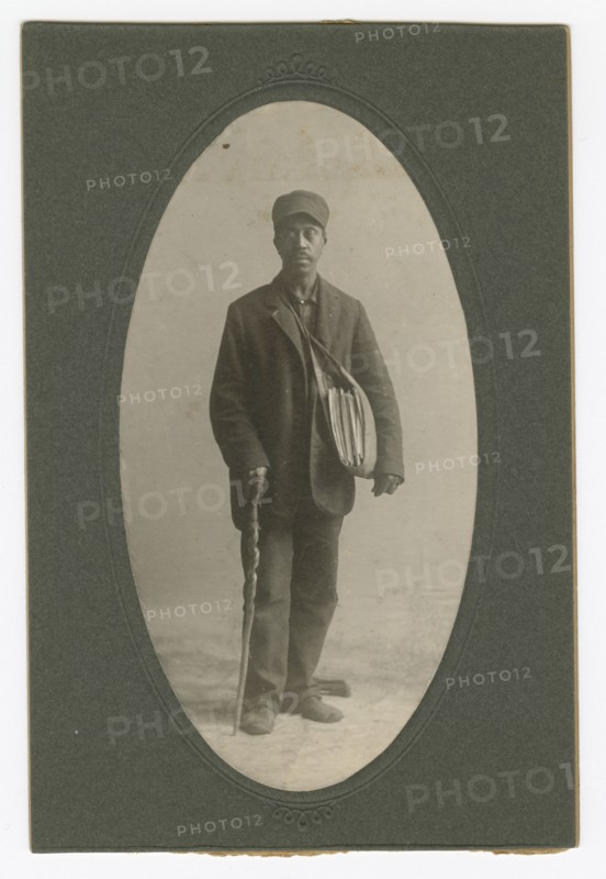 Cabinet card of a newspaper carrier, mid to late 19th century. Creator: Unknown.