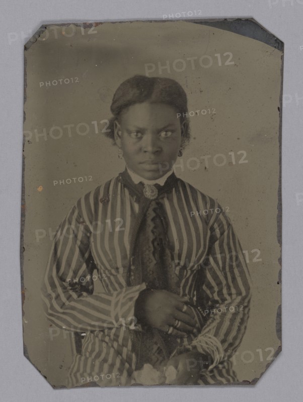 Tintype of young woman in striped dress, Late 1860s. Creator: Unknown.