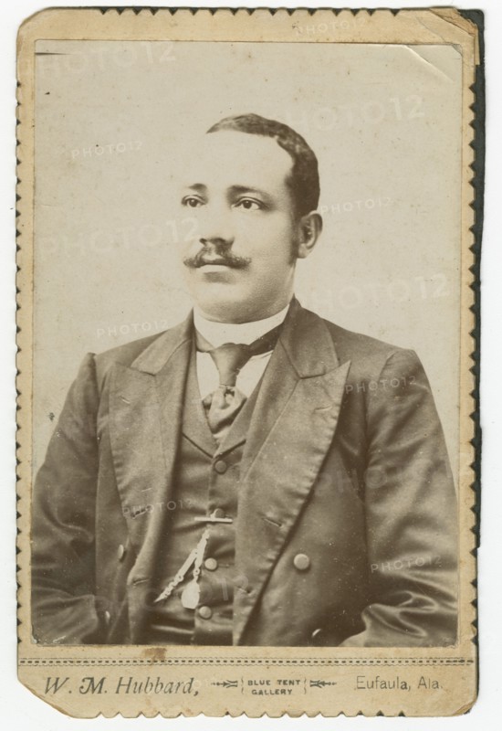 Photograph of a man wearing a dark colored suit with a pocket watch in his vest, 1886-1900. Creator: W. M. Hubbard.
