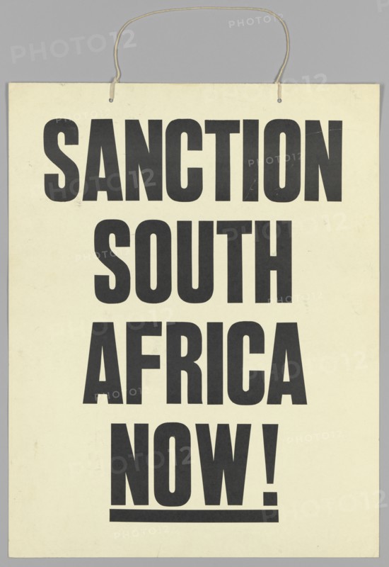 Placard reading "Sanction South Africa Now!", late 20th century. Creator: Unknown.