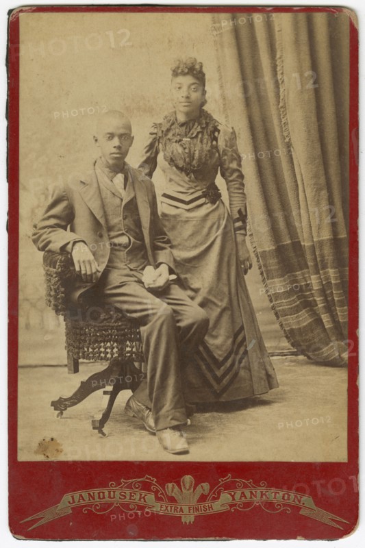 Photograph of African-American man and woman in formal clothes, late 19th century. Creator: Louis Janousek.