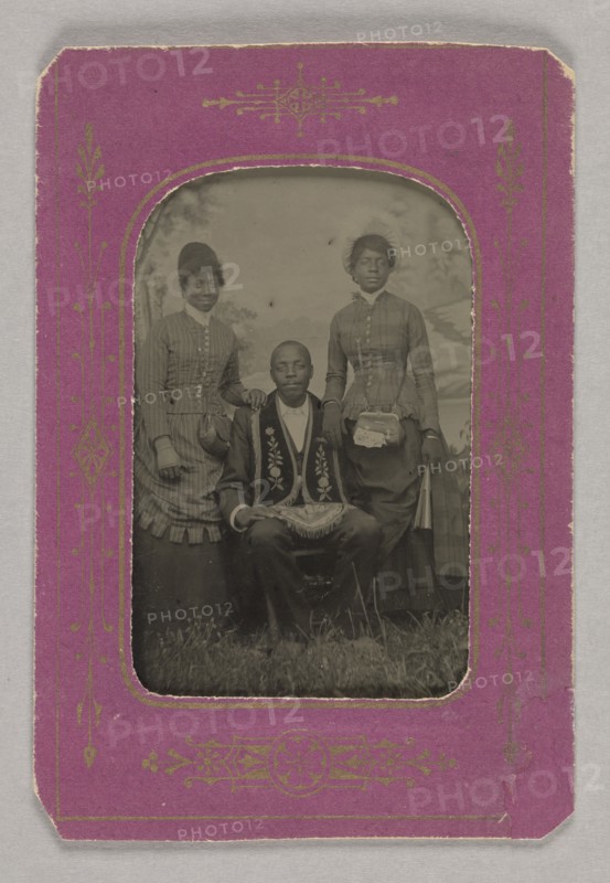 Tintype photograph of a man identified as James Turner, with two women, ca. 1873. Creator: H.G. Pearce.