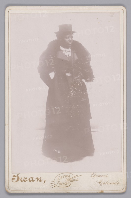 Cabinet card of an unidentified woman wearing a top hat and a fur stole, ca. 1895. Creator: Justus C. Swan.