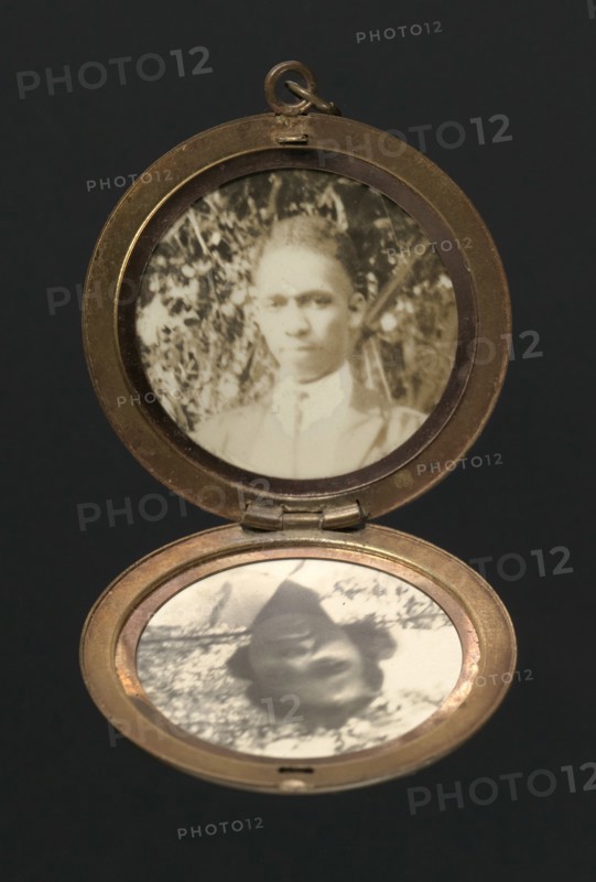 Locket with photographs of Harriette and Harry T. Moore, early to mid 20th century. Creator: Unknown.