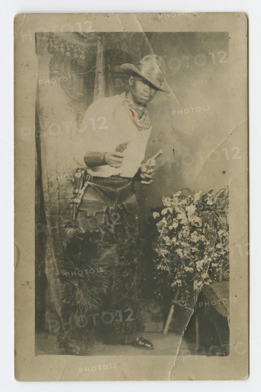 Photograph portrait of a man dressed as a cowboy, early 20th century. Creator: Unknown.