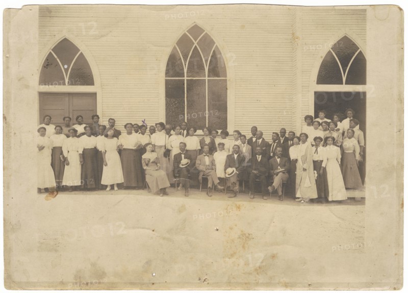 Photographic print of men and women in front of Vernon AME Church, Tulsa, ca. 1919. Creator: Unknown.