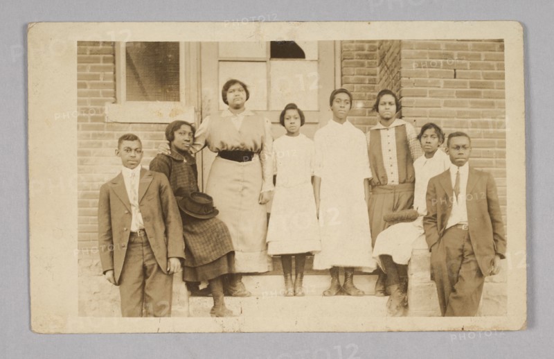 Photographic print of 8 people in front of a building, 1904-1918. Creator: Unknown.