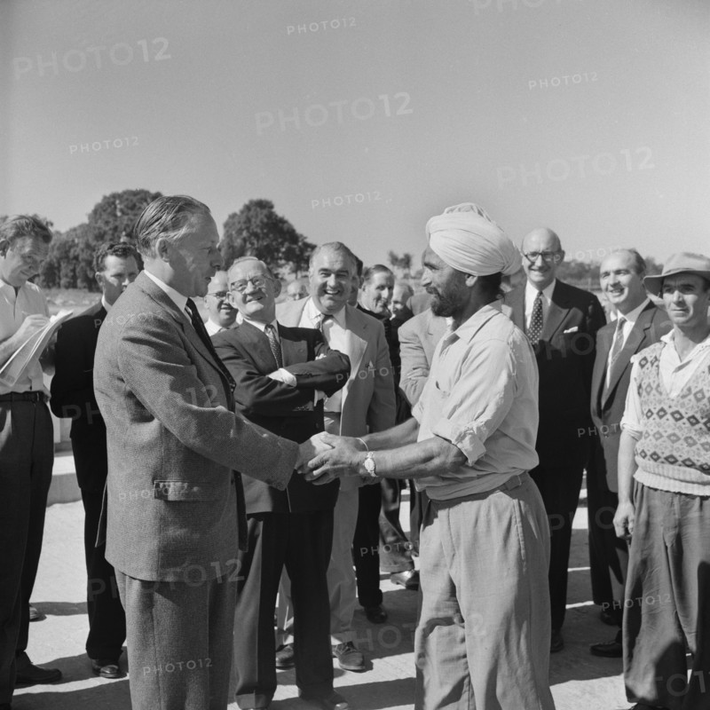 Harold Watkinson, shaking hands with labourer J. Singh, during a visit.., 07/09/1959. Creator: John Laing plc.