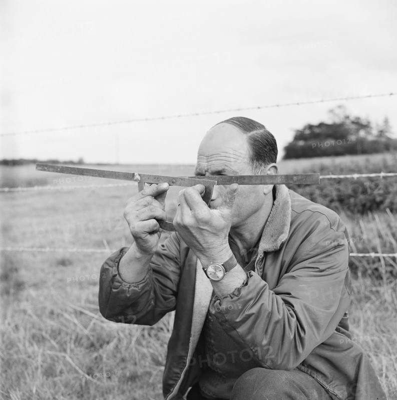 A man holding a surveyor's protractor working on the route of the Mersey oil pipeline, 24/09/1967. Creator: John Laing plc.
