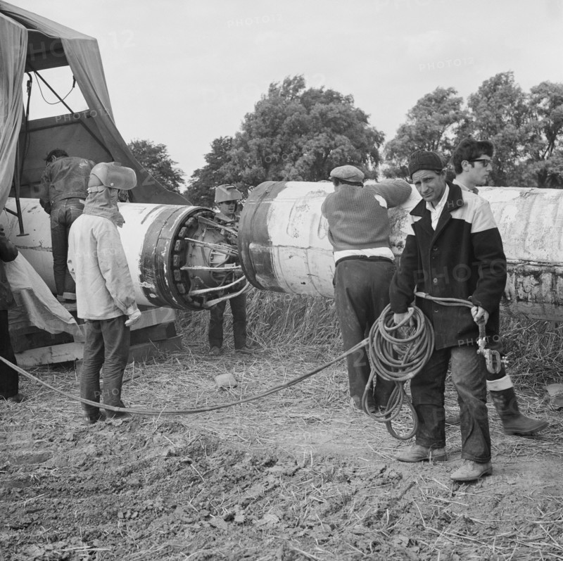 A team of men working on the lining up operation of the Fens gas pipeline, Norfolk, 24/07/1967. Creator: John Laing plc.