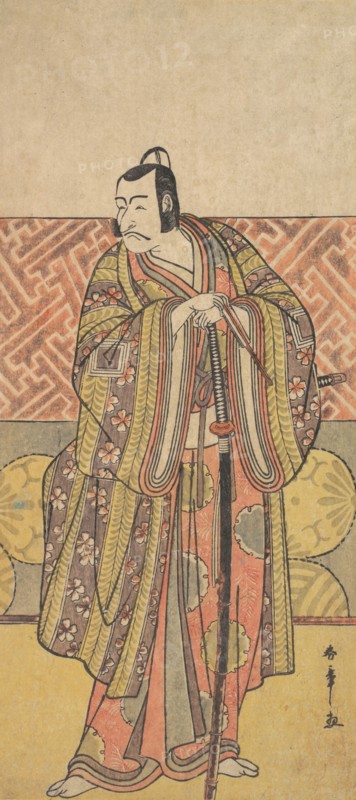 Ichikawa Danjuro V as Kudo Suketsune, Richly Attired, Leaning on His Sword, late 18th century. Creator: Shunsho.