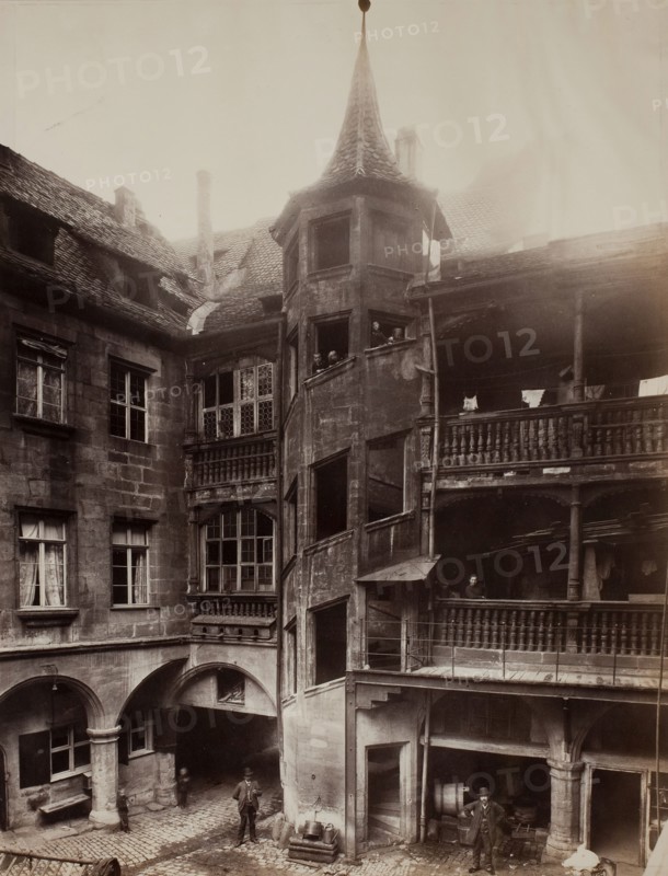 Untitled [courtyard with balconies and spiral staircase], 1870s.  Creator: Unknown.
