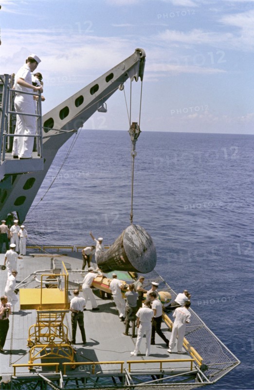 Gemini 5 capsule hoisted onboard recovery ship, 1965. Creator: NASA.