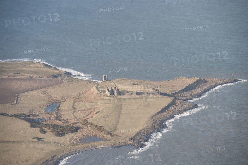 Remains of the 14th century Dunstanburgh Castle, Northumberland, 2015. Creator: Historic England.