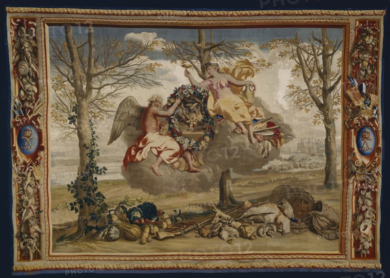 Winter, from The Seasons, Paris, 1700/20. Saturn (god of agriculture and time) and Juventas (cupbearer to the gods on Mount Olympus) floating on a cloud. Below are winter vegetables, a gun, nets and game from a hunt. In the background is the Palais du Louvre in Paris. Woven at the workshop of Etienne Le Blond and Jean de La Croix at the Manufacture Royale des Gobelins, after a design by Charles Le Brun.