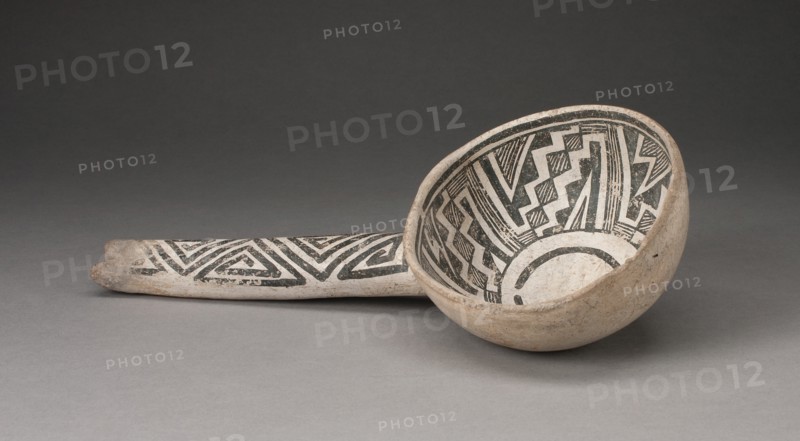Dipper or Ladle with Interlocking Zigzag and Step-Fret Designs, A.D. 1000/1300. A ceramic vessel with a long handle, its bone-white surface decorated with black geometric designs.
