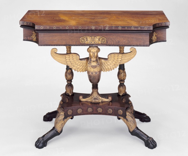Card Table, c. 1815. Mahogany with rosewood veneer, giltwood, brass and ebony inlay, winged caryatid central support.