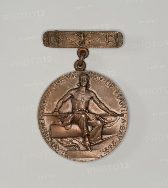 Dewey medal, c. 1898. 'In Memory of the Victory of Manila Bay, May 1 1898'. The Battle of Manila Bay took place during the Spanish-American War, and was fought between the American Asiatic Squadron under Commodore George Dewey, and the Spanish Pacific Squadron under Contraalmirante (Rear admiral) Patricio Montojo. Designed by Daniel Chester French.
