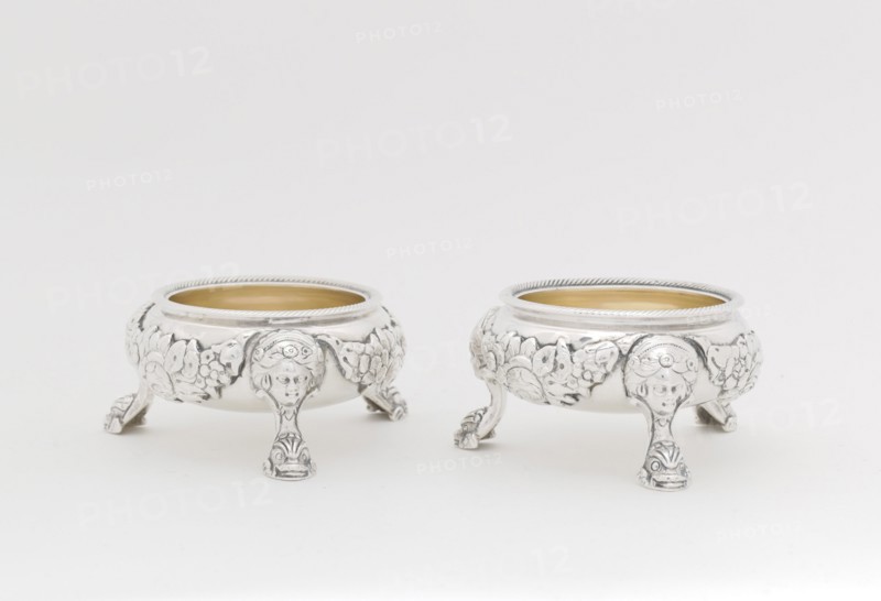Pair of Salts, 1790/95. Legs in the form of a human face with stylised dolphin or fish at the foot.