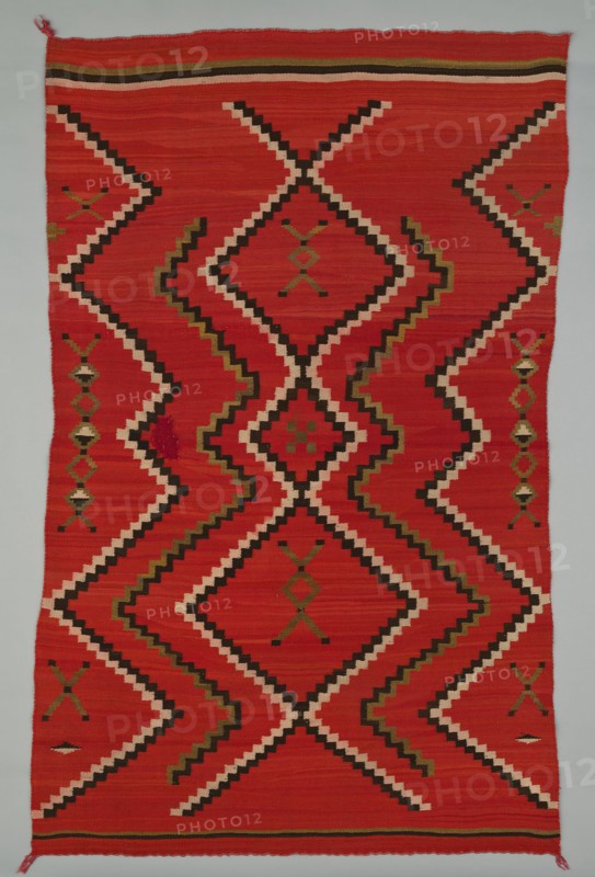 Sarape with Terraced Zigzag Design, 1865/85. A work made of wool, plain weave and dovetail tapestry weave; twined warp ends and selvages; looped and knotted corner tassels.