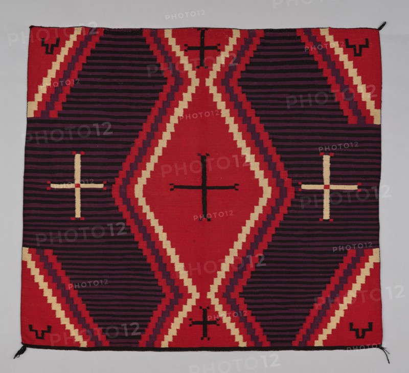 Chief Blanket (Third Phase), c. 1880. A work made of wool, dovetail tapestry weave with "lazy lines"; twined warp ends and selvages; corner tassels.