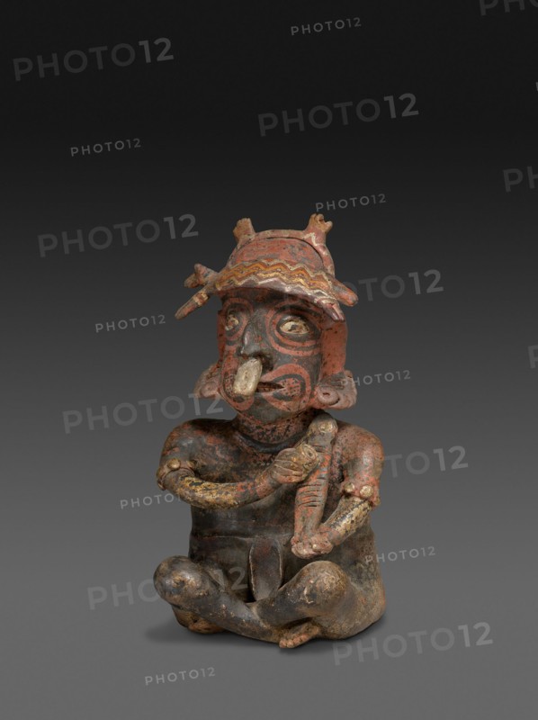 Seated Figure Playing a Rasp, c. A.D. 100.