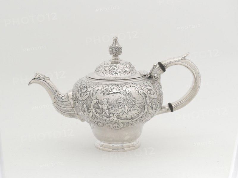 Teapot, 1848. Repoussé decoration, man carrying a yoke laden with baskets of produce.