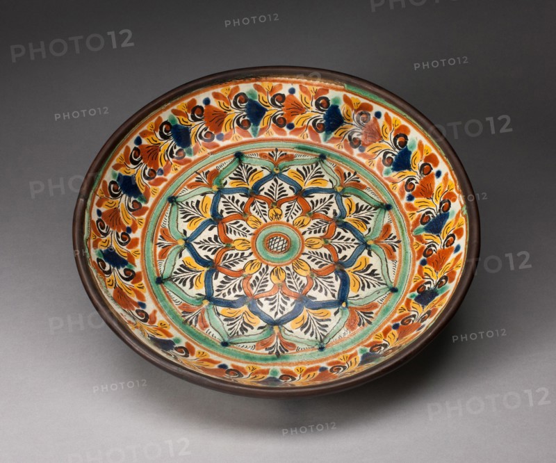 Plate, 1800/50. Glazed earthenware plate decorated with stylized leaves and flowers in red, yellow, green, dark blue, and white.