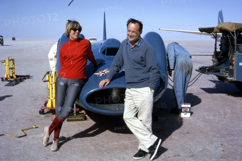 Donald Campbell with his wife Tonia and Bluebird CN7, Lake Eyre, Australia, 1964. Creator: Unknown.