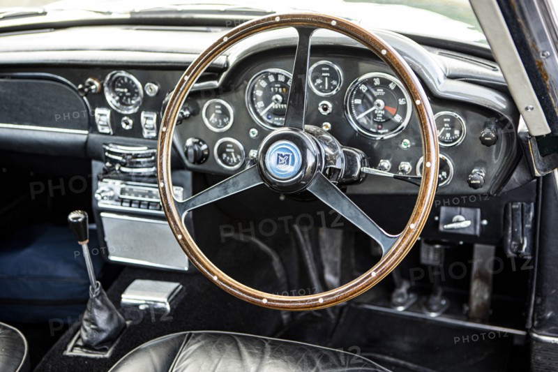 Steering wheel and dashboard of a 1965 Aston Martin DB5. Creator: Unknown.