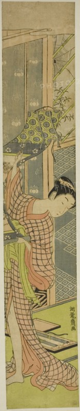 Young Woman Hanging a Painting, c. 1771. Creator: Isoda Koryusai.