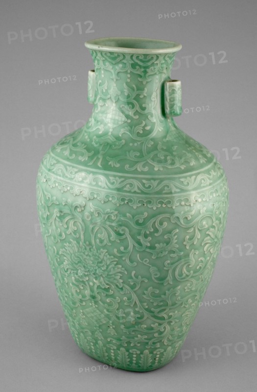 Jar with Tubular Handles, Peonies, 'Endless Knot,' Pendant Balls, and Pendant Lozenges, Qing dynasty (1644-1911), Qianlong reign mark and period (1736-1795). Green glazed vessel decorated with floral adornments, tapered and flared at the neck, with two small cylindrical handles.