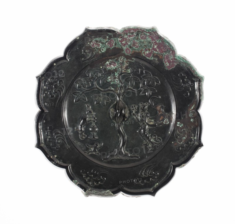 Lobed Mirror with Images of the Moon Palace Hare Pounding Elixir, Toad, and Chang E Holding Peaches of Immortality, Tang dynasty (A.D. 618-907), 8th century.
