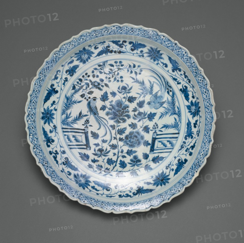 Shallow Dish with Long-Tailed Birds in a Garden of Stylized Peonies and Fronds, Encircled by a Scrolling Wreath of Camellia and Lotus Blossoms, Yuan dynasty (1279-1368), early/mid-14th century.