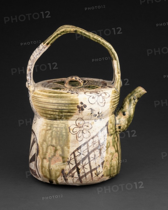 Oribe-Type Ewer, early 17th century. Greenish brown ceramic kettle with floral and geometric designs.