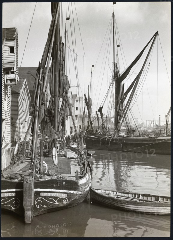 Sailed fishing vessels moored beside timber warehouses at Rochester, Medway, 1925-1935. Creator: J Dixon Scott.