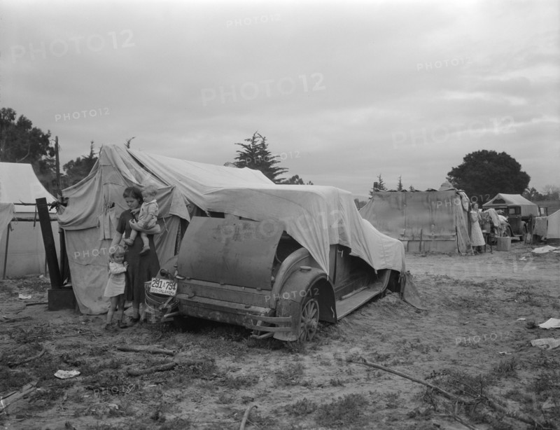 Migrant family looking for work in the pea fields, California, 1936. Creator: Dorothea Lange.
