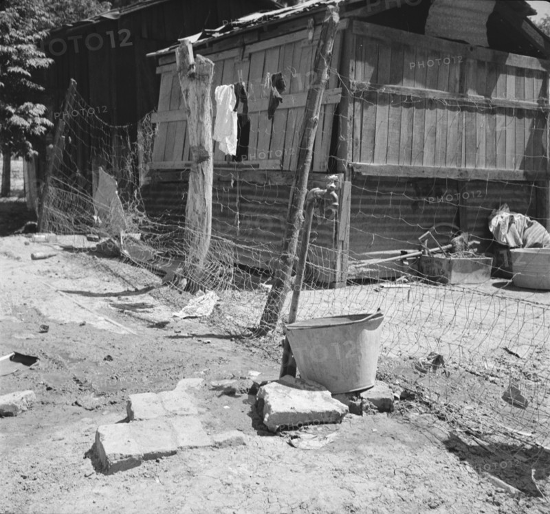 Home of Mexican field worker showing water supply, Brawley, Imperial Valley, California, 1935. Creator: Dorothea Lange.
