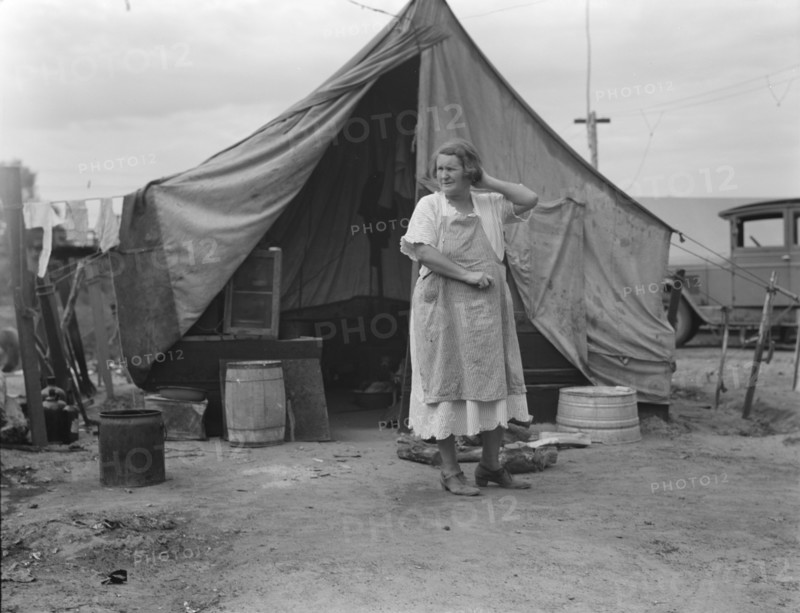 Mother of family of migrant fruit workers encamped on outskirts of Porterville, California, 1936. Creator: Dorothea Lange.
