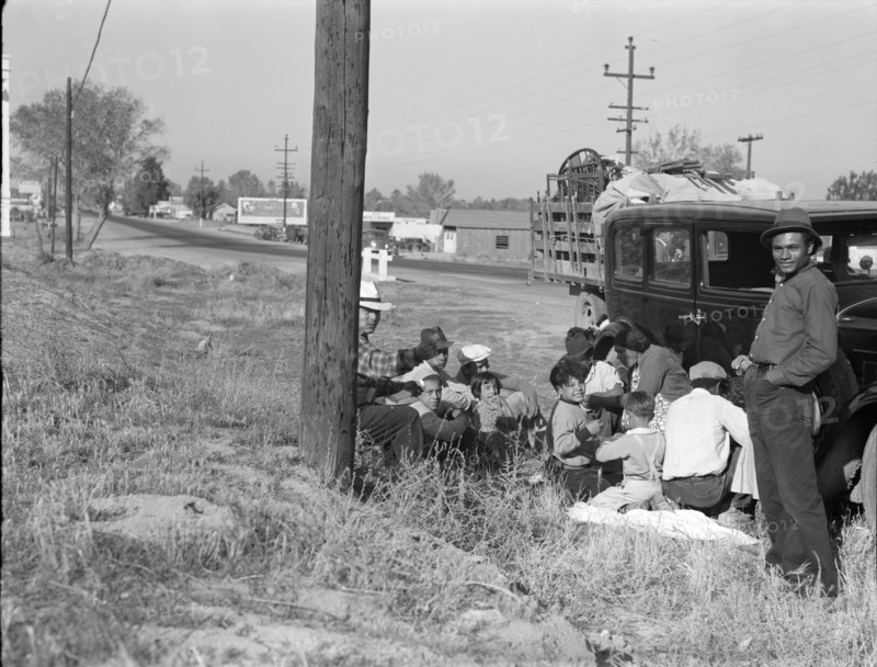 Mexicans bound for the Imperial Valley to harvest peas, near Bakersfield, California, 1936. Creator: Dorothea Lange.