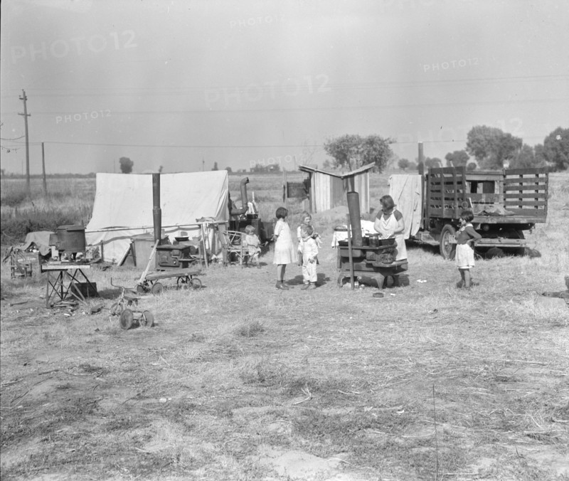 Wife and five children of migratory fruit worker, American River camp on...Sacramento, CA,1936. Creator: Dorothea Lange.
