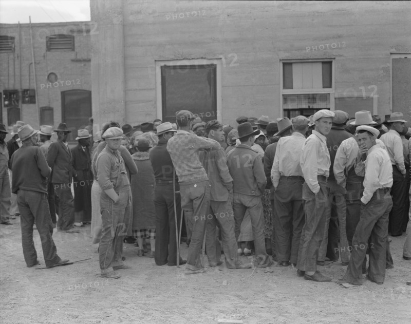 Waiting for the semi-monthly relief checks at Calipatria, California, 1937. Creator: Dorothea Lange.