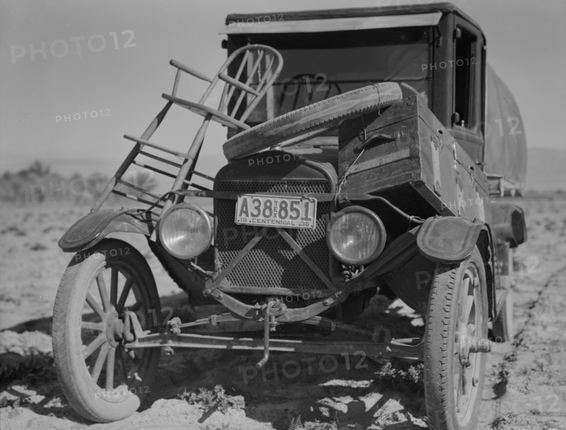 Car of drought refugee on edge of carrot field in the Coachella Valley, California, 1937. Creator: Dorothea Lange.