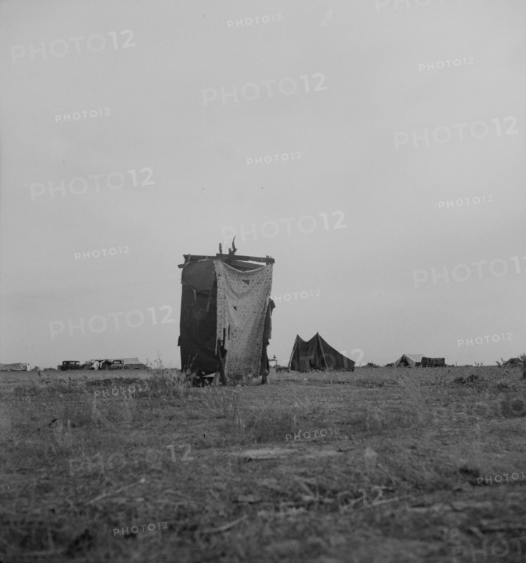 Unsanitary privy in potato pickers' camp near Shafter, California, 1937. Creator: Dorothea Lange.