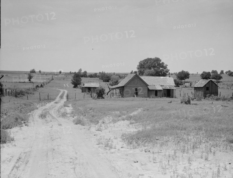 Worn-out land and abandoned cabins near Newport, Oklahoma, 1937. Creator: Dorothea Lange.