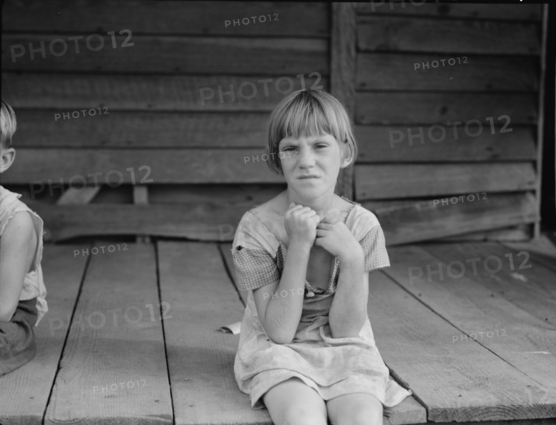 Sharecropper's child whose father receives five dollars a month, Macon County, Georgia, 1937. Creator: Dorothea Lange.