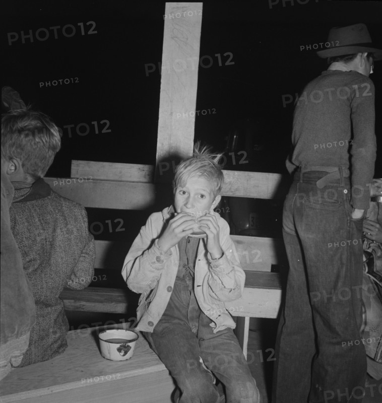Hungry boy at the Halloween party for migrant workers, Shafter migrant camp, California, 1938. Creator: Dorothea Lange.