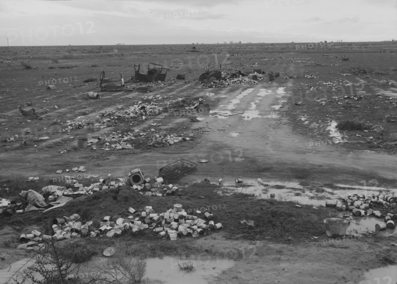 Debris left out on the flats where squatters' camp stood, Kern County, 1939. Creator: Dorothea Lange.