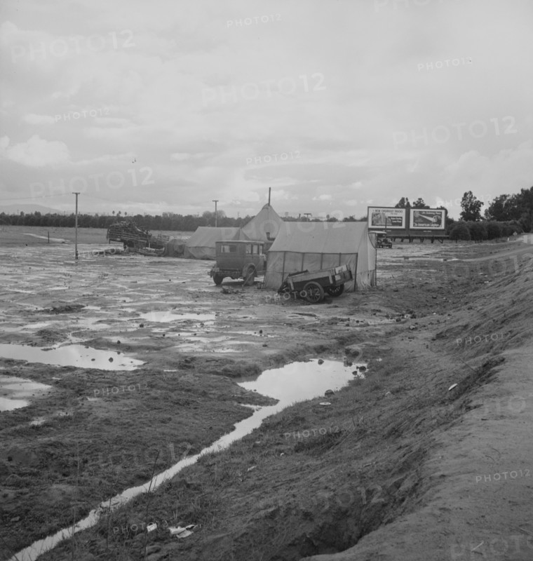Winter quarters, migratory agricultural workers, beside the highway, Tulare County, 1939. Creator: Dorothea Lange.